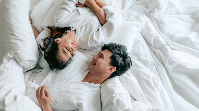 a couple hang out in bed