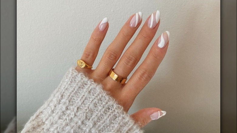 woman wearing french swirl manicure