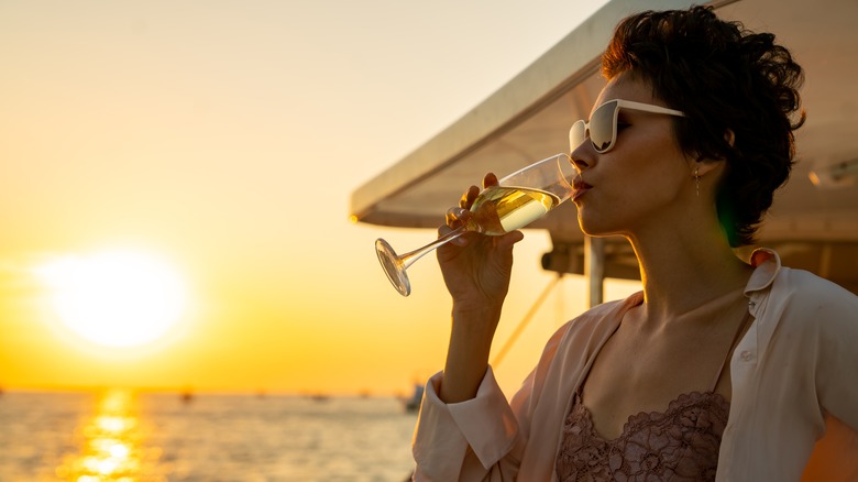 confident woman sipping champagne 
