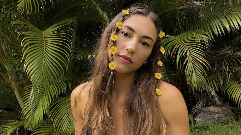 A woman with flowers in baby braids