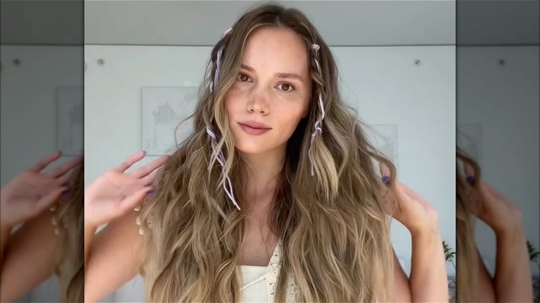 A woman with string in her baby braids