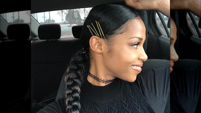 A woman with bobby pins on the side of her head