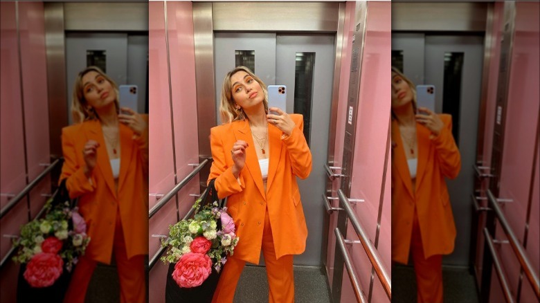woman wearing orange power suit