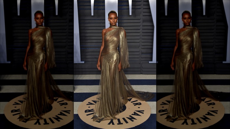 jasmine tookes wearing sheer gold dress