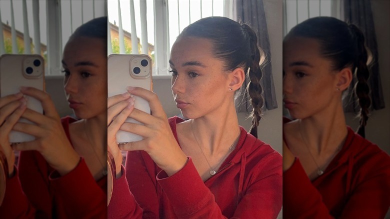 woman with slicked back high braided ponytail