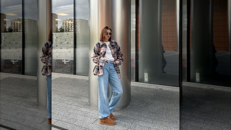 Woman wearing a plaid shirt and Uggs