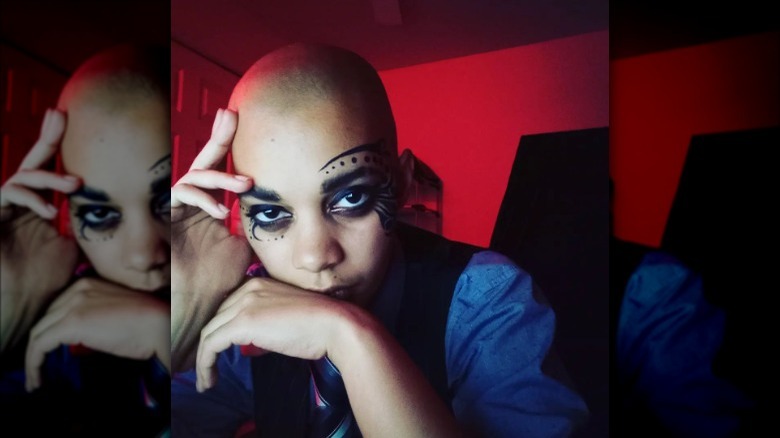 person wearing asymmetrical black graphic eyeliner