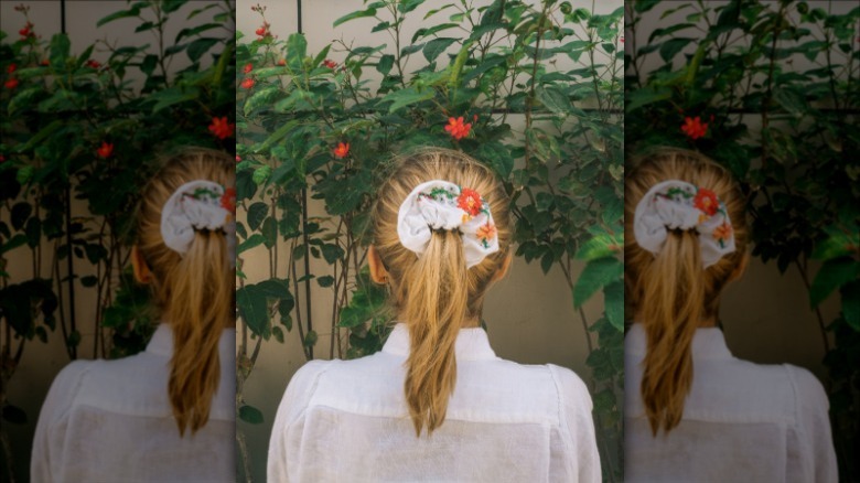 woman wearing floral scrunchie