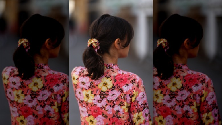 woman wearing orange pink floral scrunchie