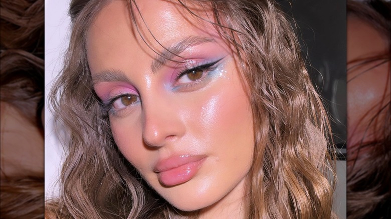 A woman with pink eye makeup