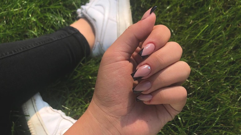 hand with black chevron french nails