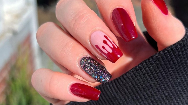 hand with blood red french manicure