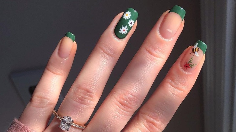 hand with green french manicure