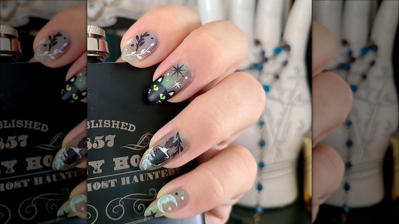 hand with black cat french manicure