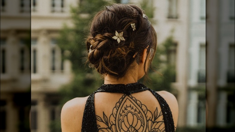 woman hair bun with tattoos