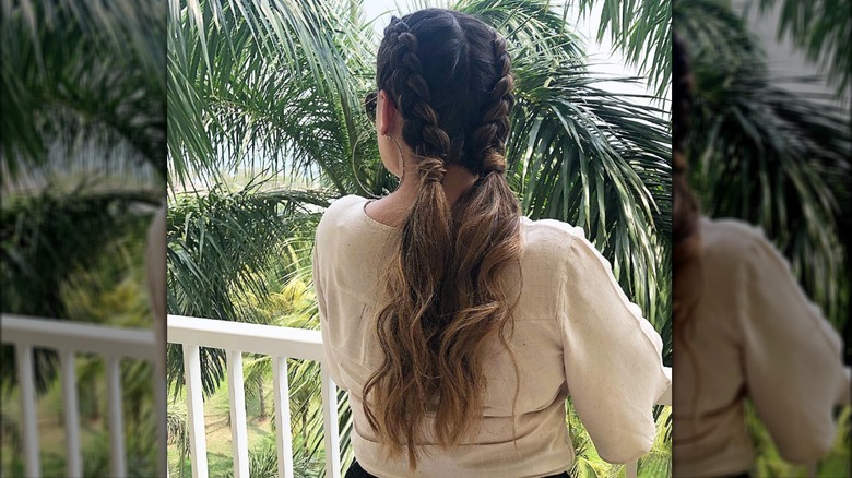 woman on balcony with braids