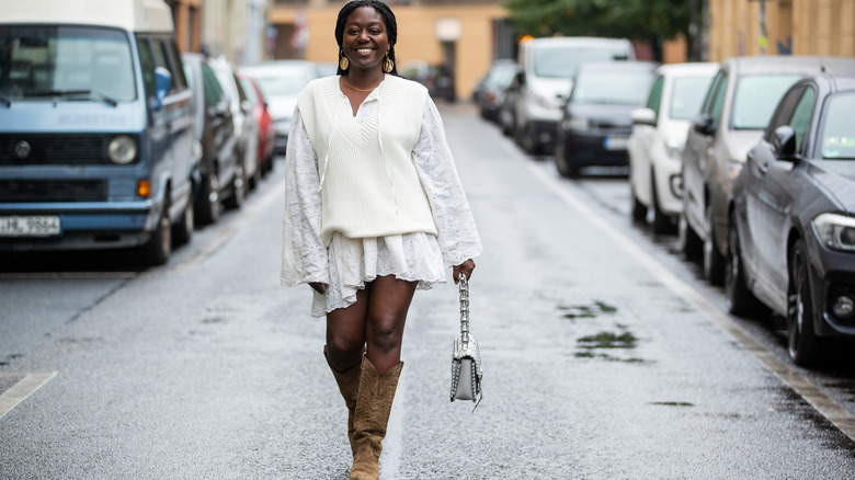 Woman wearing mini dress under sweater
