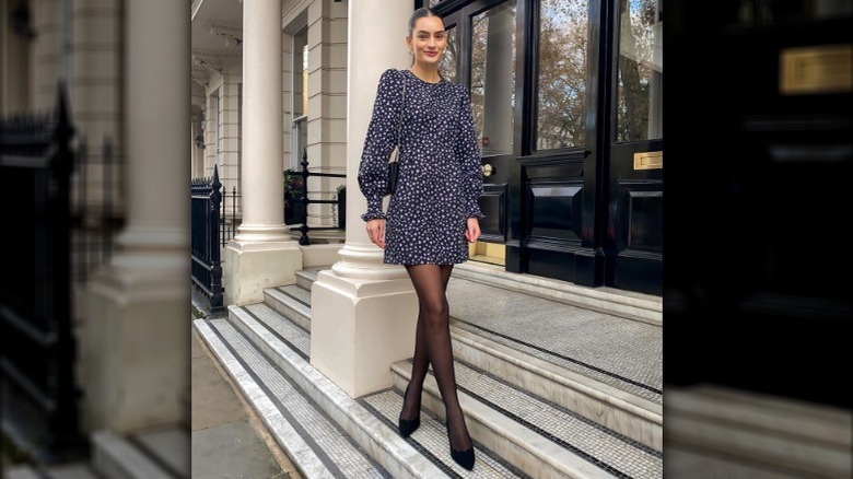 Woman wearing mini dress black accessories