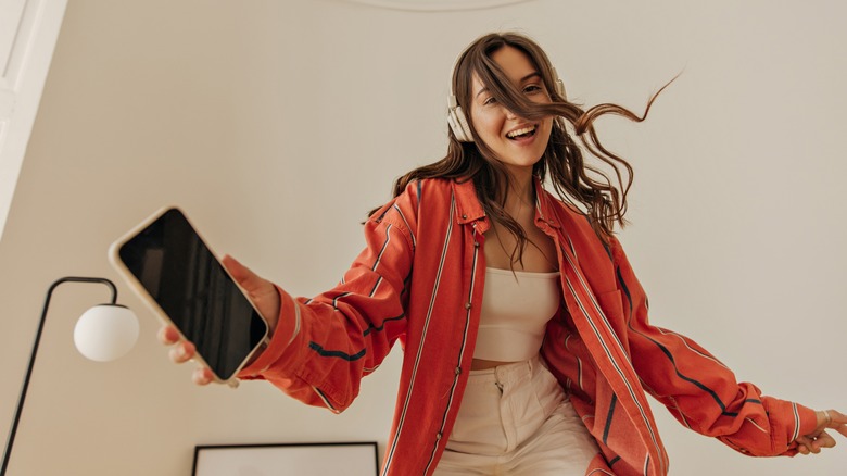 woman dancing with headphones on