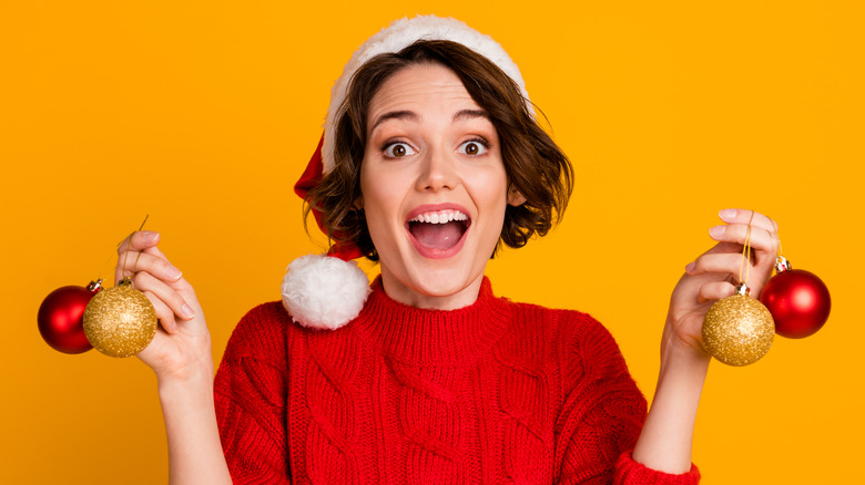 woman holding Christmas ornaments