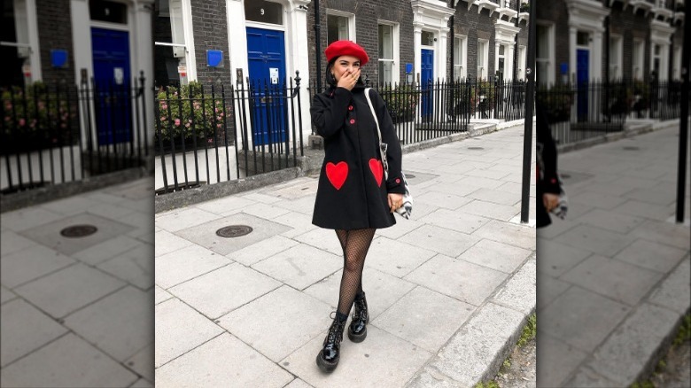 Woman in dress, fishnet stockings, and Doc Martens