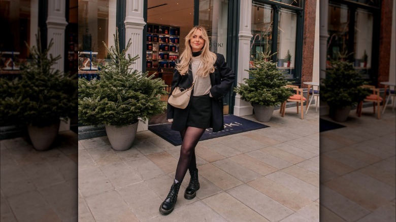 Woman in sheer tights, skirt, and Dr Martens