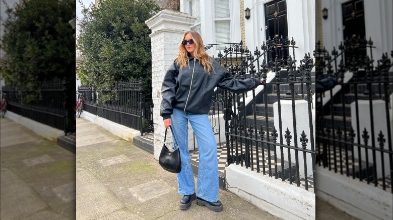 Woman in wide leg blue jeans and Doc Marten boots