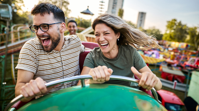couple riding roller coaster