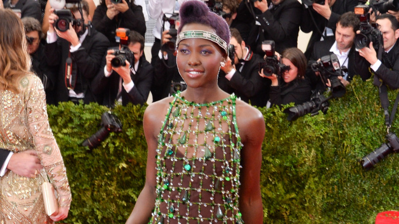 Lupita Nyong'o at Met surrounded by photographers