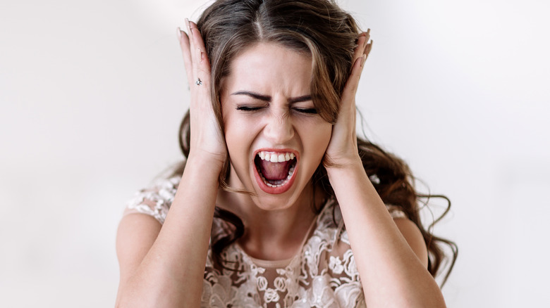 Bridezilla screaming, hands on ears