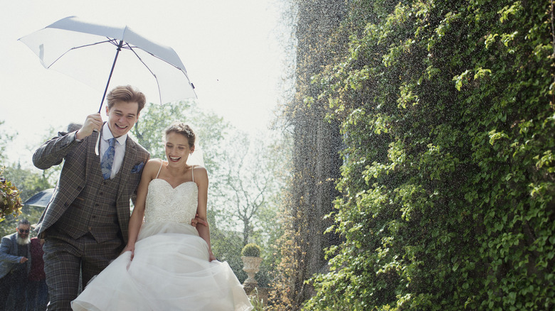 Couple experiencing wedding day rain