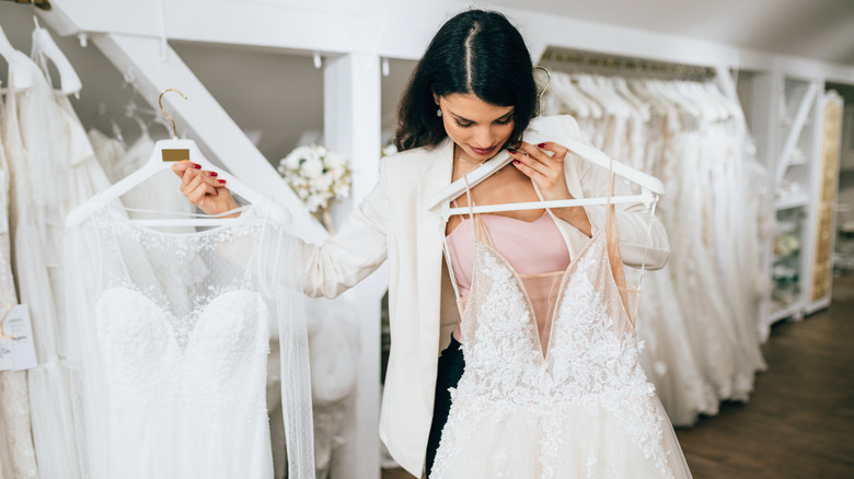 Bride looking at gowns
