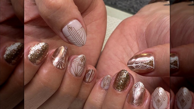 An art-deco manicure with white-and-gold nails