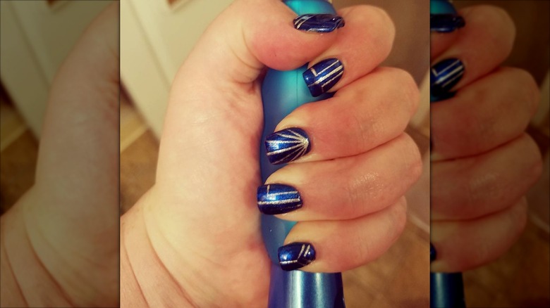 An art-deco manicure with blue-and-gold nails