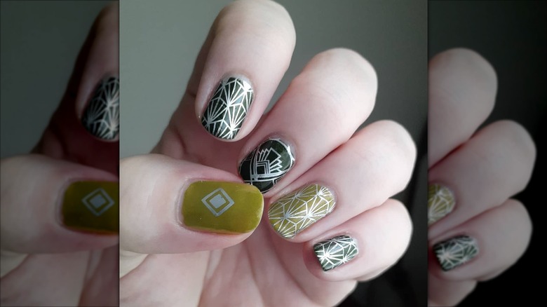 An art-deco manicure with green-and-silver nails