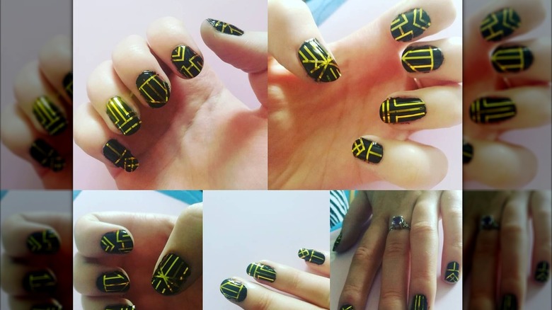 An art-deco manicure with bright-gold line work on the nails