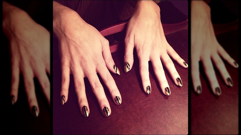 An art-deco manicure with black-and-gold nails