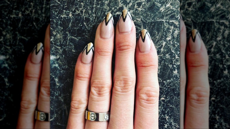 An art-deco manicure with black-and-gold nails
