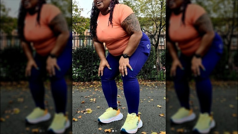 Laughing black woman blue athletic plants