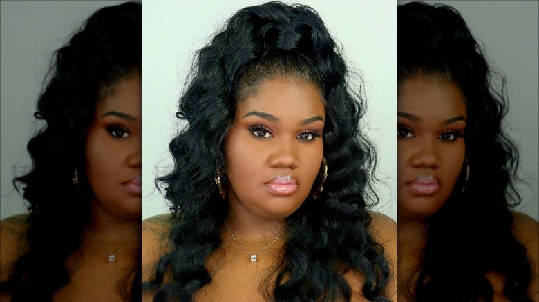 Woman with sleek half-up hairstyle