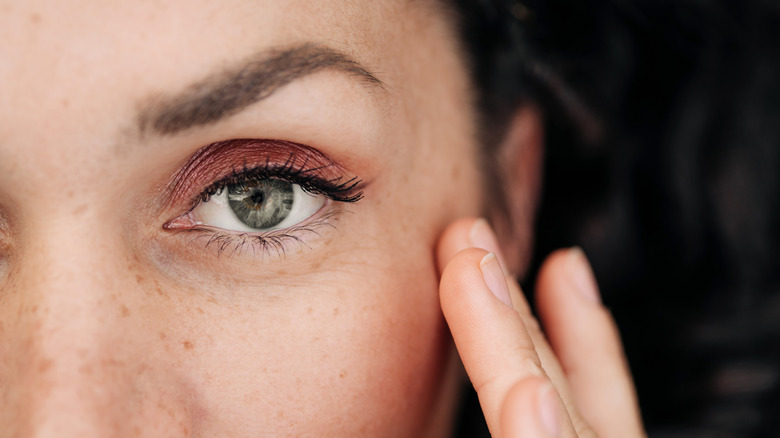 Woman with copper eyeshadow and green eyes