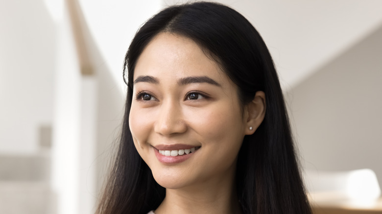 Woman with straight black hair smiling