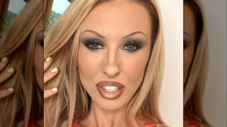 Woman with thin brows and lots of makeup