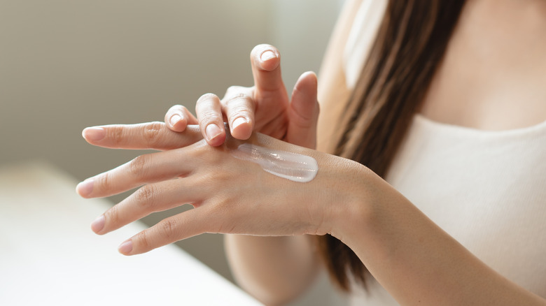 Someone applying hand cream to their hand