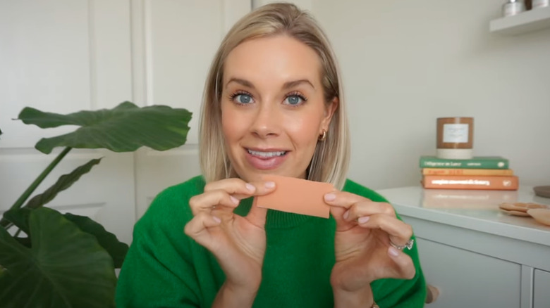 A person holding up adhesive tape