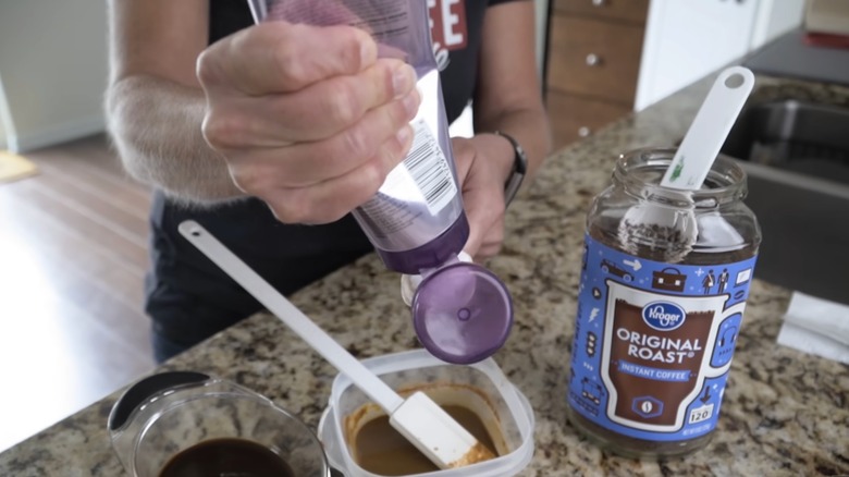 A woman mixing coffee and hair conditioner to make an at-home dye