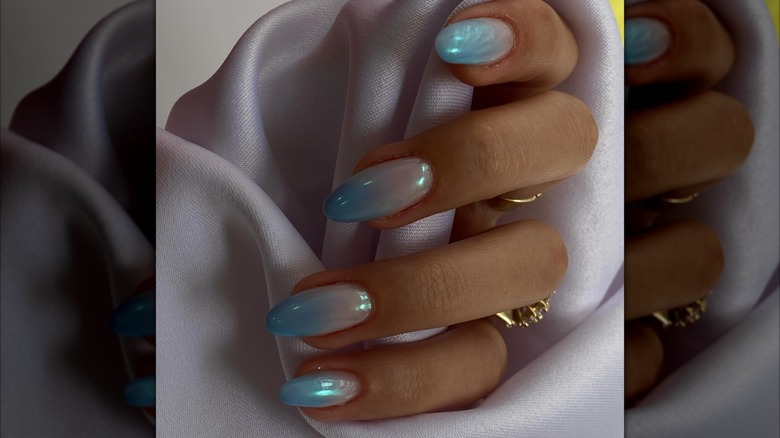 A blue ombré nail art design.