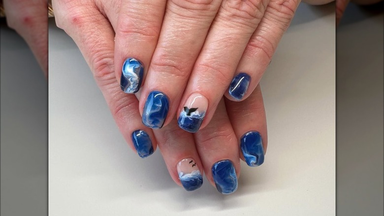 An ocean-inspired nail art design with a whale tail.