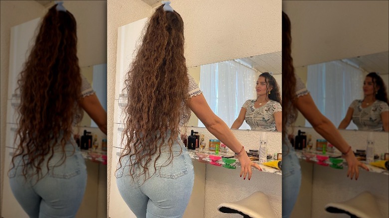 woman with hip length curly hair