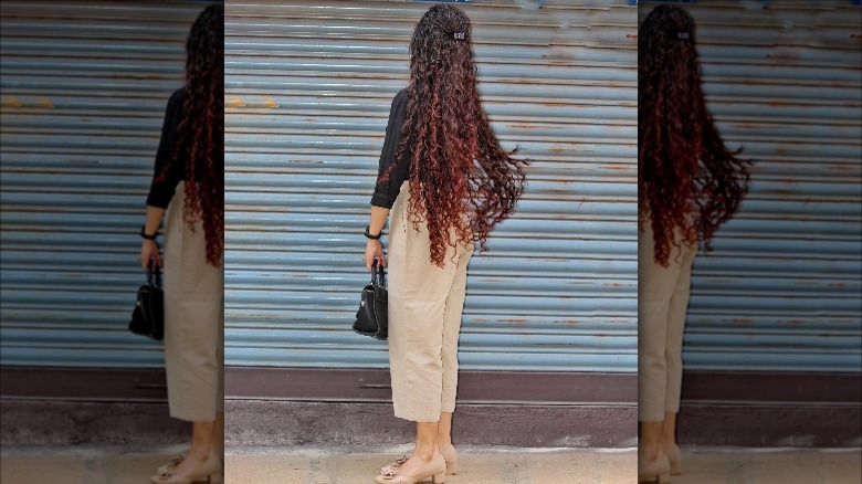 woman with long half up curly hair